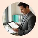 ATM service manager reviewing maintenance records with a tablet